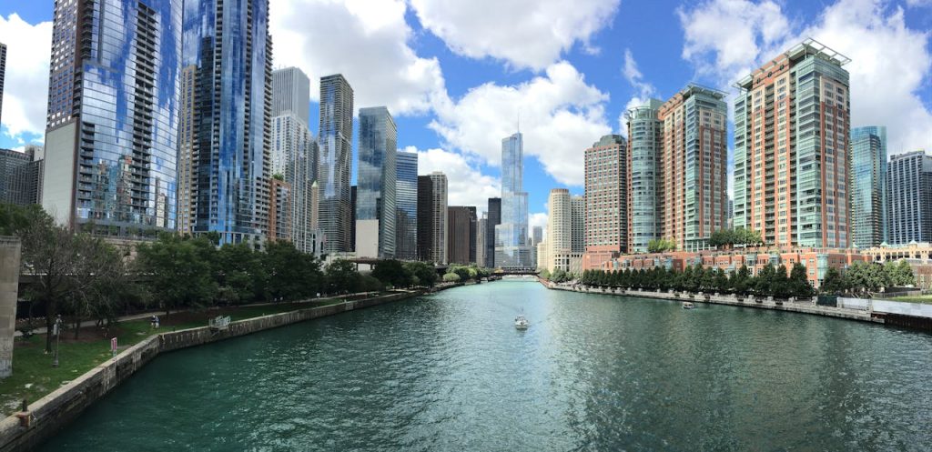 Stunning view of Chicago skyline along the river under a clear blue sky.